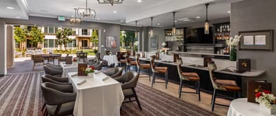 Dining area with tables and chairs overlooking outdoor space