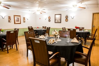 Elegant dining room setup with tables and flowers