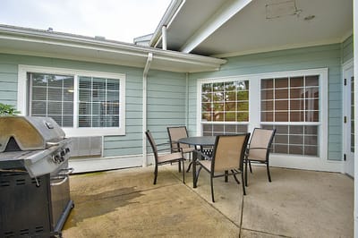 Outdoor patio area with seating and grill