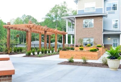 Outdoor garden area with wooden structure and flower beds