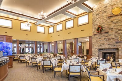 Bright dining room with festive decor and tables set
