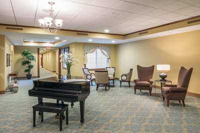Well-lit interior lounge with seating and a piano