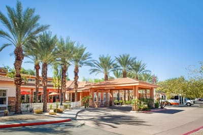 Exterior view of Sunrise of Chandler with palm trees and entrance