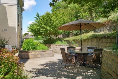 Outdoor seating area with umbrella and plants