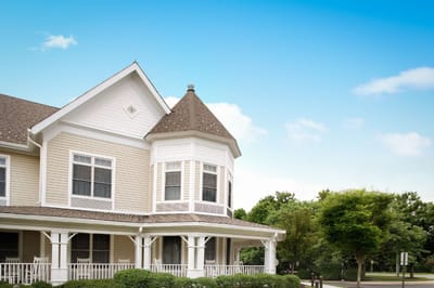 Exterior view of a senior living facility with garden