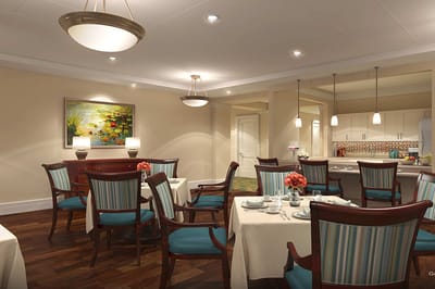 Well-lit dining area with tables and chairs