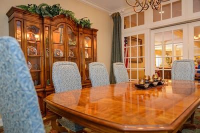 Elegant dining area with table and decorative cabinet