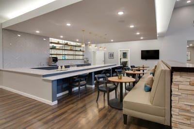 Interior view of a common area with seating and a coffee station