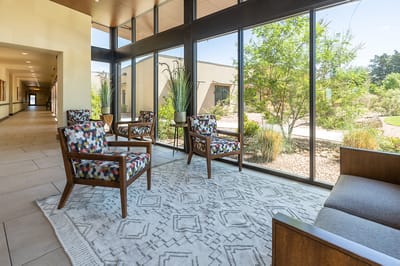Bright common area with seating and garden view