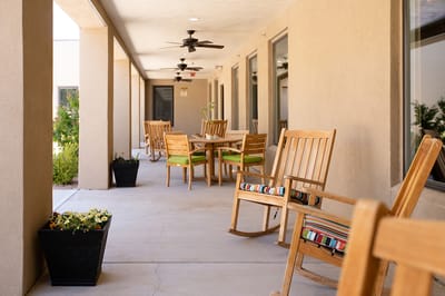 Porch with rocking chairs and outdoor tables