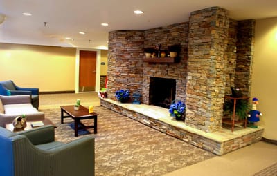 Cozy lobby area with a stone fireplace and seating