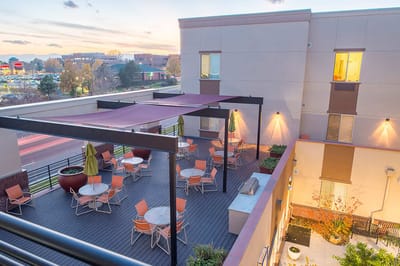 Outdoor seating area with tables and umbrellas