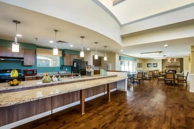 Bright dining area with a kitchen and seating
