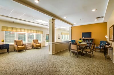 Bright common area with seating and bookshelf