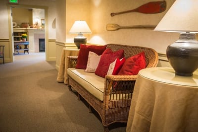 Cozy common area with a wicker sofa and decorative pillows
