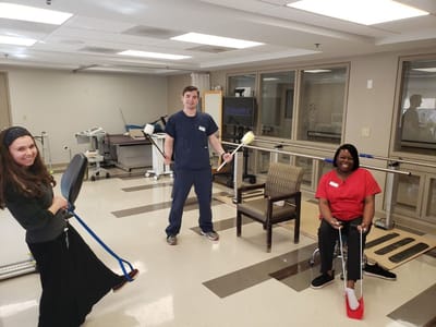 Staff engaging with residents in a rehabilitation activity