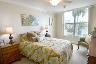 Cozy bedroom with floral decor and lake view