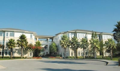 Exterior view of Westminster St. Augustine with palm trees