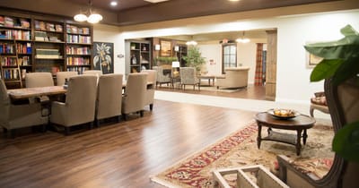 Interior of a cozy common area with bookshelves and seating