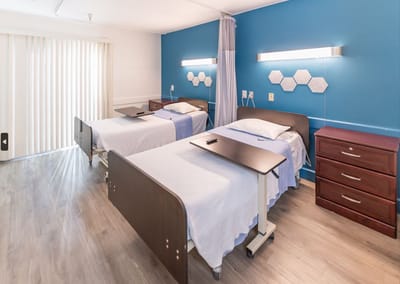 Spacious room with two beds and modern decor