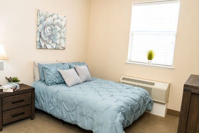 Cozy interior of a private resident room with a bed and decor
