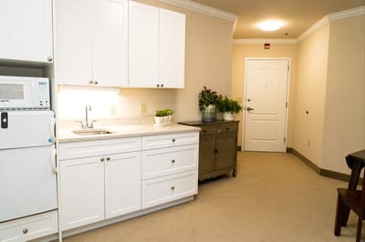 Interior view of a resident room with kitchen space