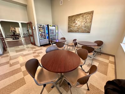 Seating area in a common room with tables and chairs