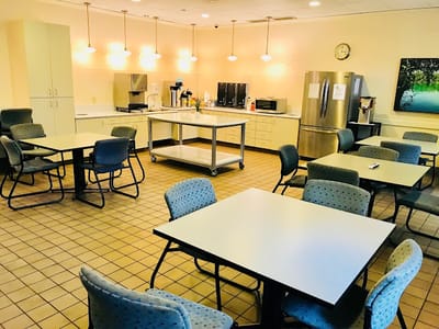 Dining area with tables and kitchen appliances