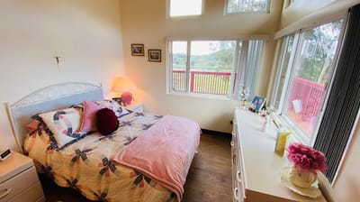 A cozy private resident room with a bed and windows