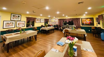 Dining area setup with tables and flower arrangements