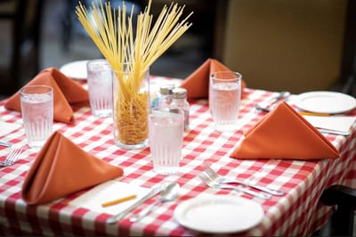 Dining table set with glasses and decorative napkins