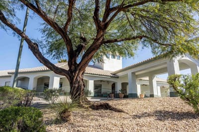 Exterior view of a senior living facility with landscaping