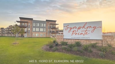 Building exterior of Symphony Pointe with community sign
