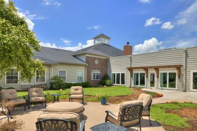 Outdoor seating area with gardens at a senior living facility