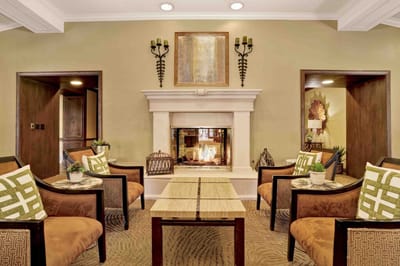 Common area with seating around a fireplace