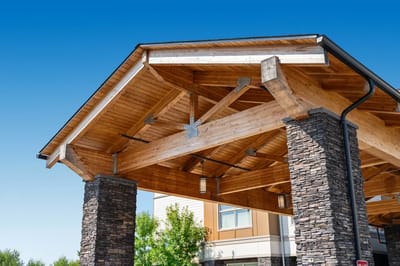 Exterior view of a facility entrance with wooden beams