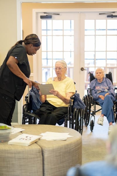 Staff assisting residents in a common area