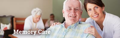 Smiling resident and staff member in a facility setting