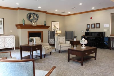 Bright common area with seating and piano