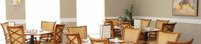 Bright dining area with tables and chairs set for meals