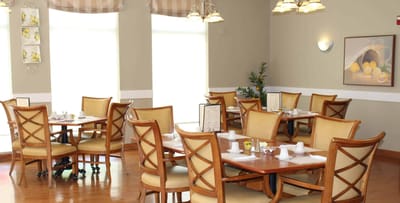 Bright dining area with wooden tables and chairs