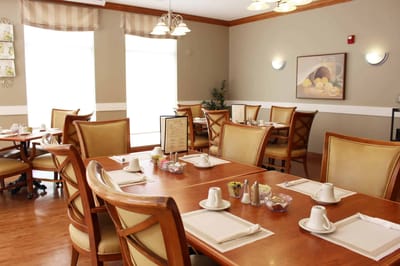 Dining room with tables set for residents
