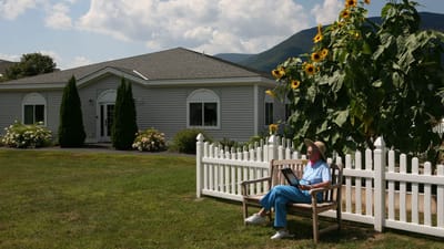 Resident enjoying the outdoors near the facility