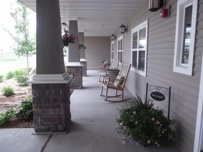 Covered porch with rocking chairs and flower pots