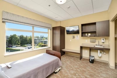 Bright private resident room with modern furnishings and a view