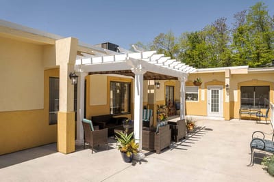 Outdoor patio area with seating and plants