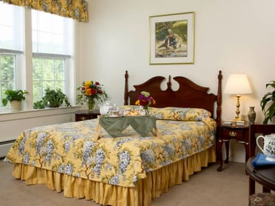 Cozy resident room with decorative bedding and snacks