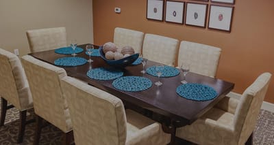 Interior dining area with a large table and decorative placemats