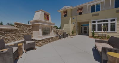 Outdoor seating area with a fireplace and seating