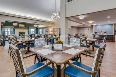Dining area with tables and chairs set for meals